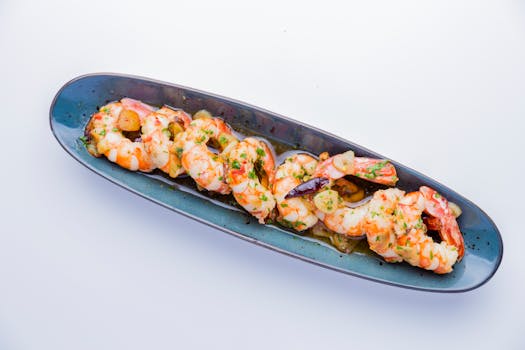 pexels-photo-4175148-4175148 Close-up of a gourmet shrimp dish served on a stylish blue plate, perfect for seafood lovers.